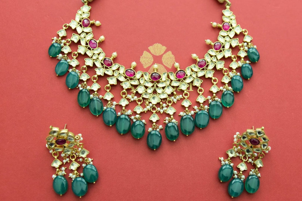 Buy gold plated heavy kundan necklace set online in USA with green drops. Elevate your traditional look with royal Amrapali jewelry, silver plated jewelry, gold plated jewelry, gold plated necklace, silver earrings, silver bangles from Pure Elegance Indian fashion store in USA.-front