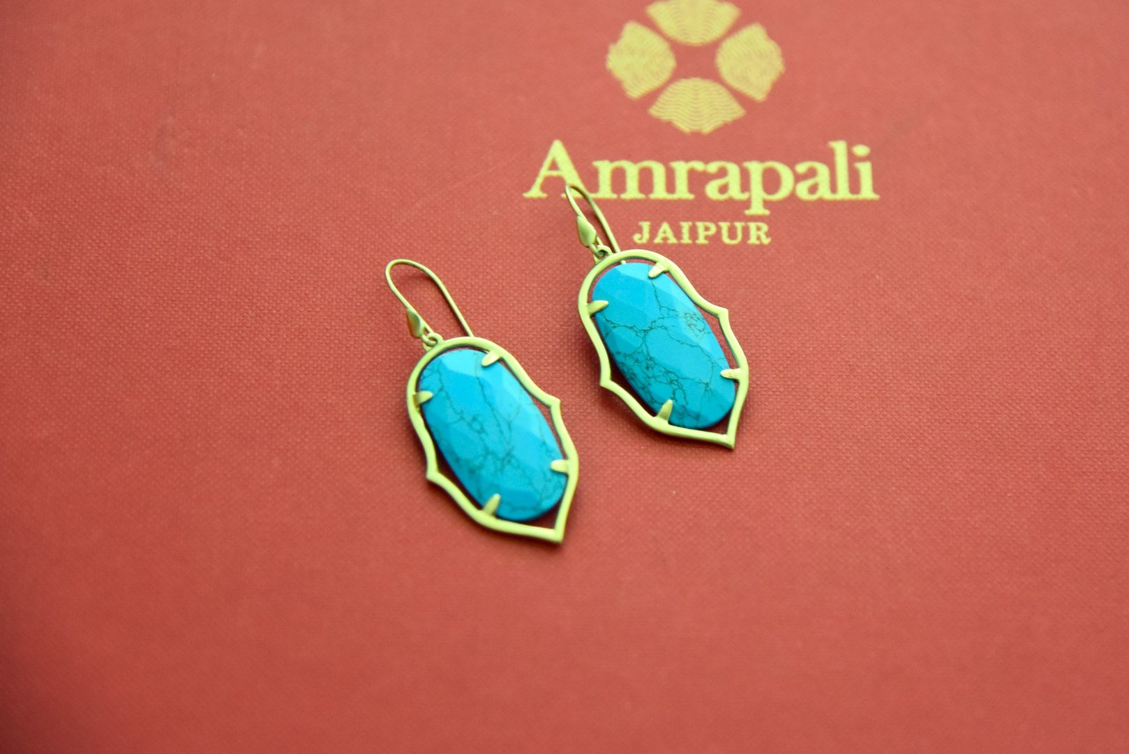 Shop gold plated earrings online in USA with turquoise stone. Elevate your traditional look with royal Amrapali jewelry, silver plated jewelry, gold plated jewelry, gold plated necklace, silver earrings, silver bangles from Pure Elegance Indian fashion store in USA.-front