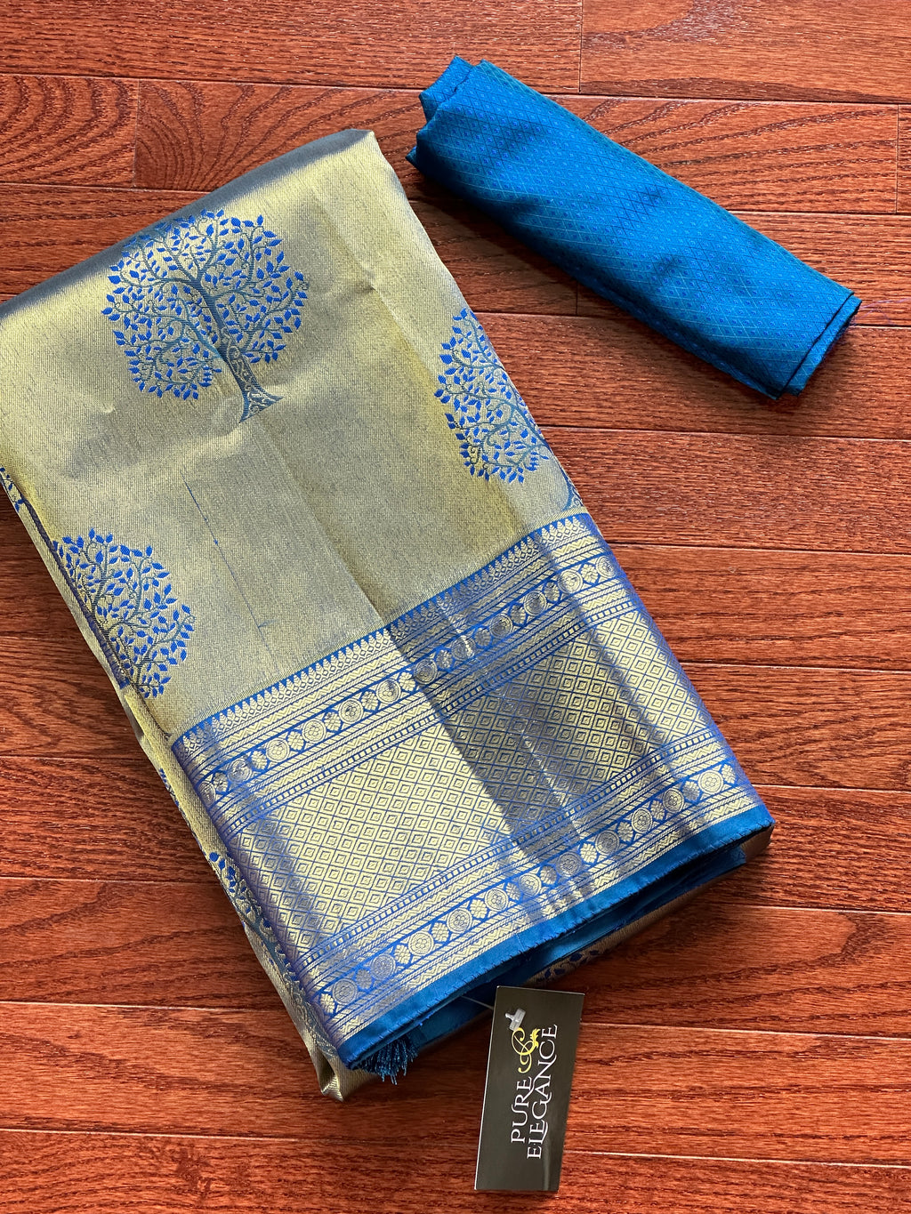 Buy golden zari blue Kanjivaram silk sari online in USA with tree motifs. Look your best on festive occasions in latest designer sarees, pure silk sarees, Kanjivaram silk saris, handwoven saris, tussar silk sarees, embroidered saris from Pure Elegance Indian clothing store in USA.-full view