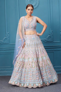 Shop this light blue and pink lehenga with heavy floral and sequin embroidery. Dazzle on weddings and special occasions with exquisite Indian designer dresses, sharara suits, Anarkali suits, bridal lehengas, and sharara suits from Pure Elegance Indian clothing store in the USA. Shop online from Pure Elegance.