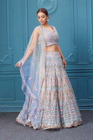 Shop this light blue and pink lehenga with heavy floral and sequin embroidery. Dazzle on weddings and special occasions with exquisite Indian designer dresses, sharara suits, Anarkali suits, bridal lehengas, and sharara suits from Pure Elegance Indian clothing store in the USA. Shop online from Pure Elegance.