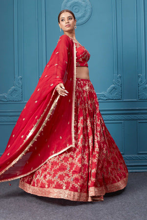 Shop this red lehenga with golden embroidery. Dazzle on weddings and special occasions with exquisite Indian designer dresses, sharara suits, Anarkali suits, bridal lehengas, and sharara suits from Pure Elegance Indian clothing store in the USA. Shop online from Pure Elegance.