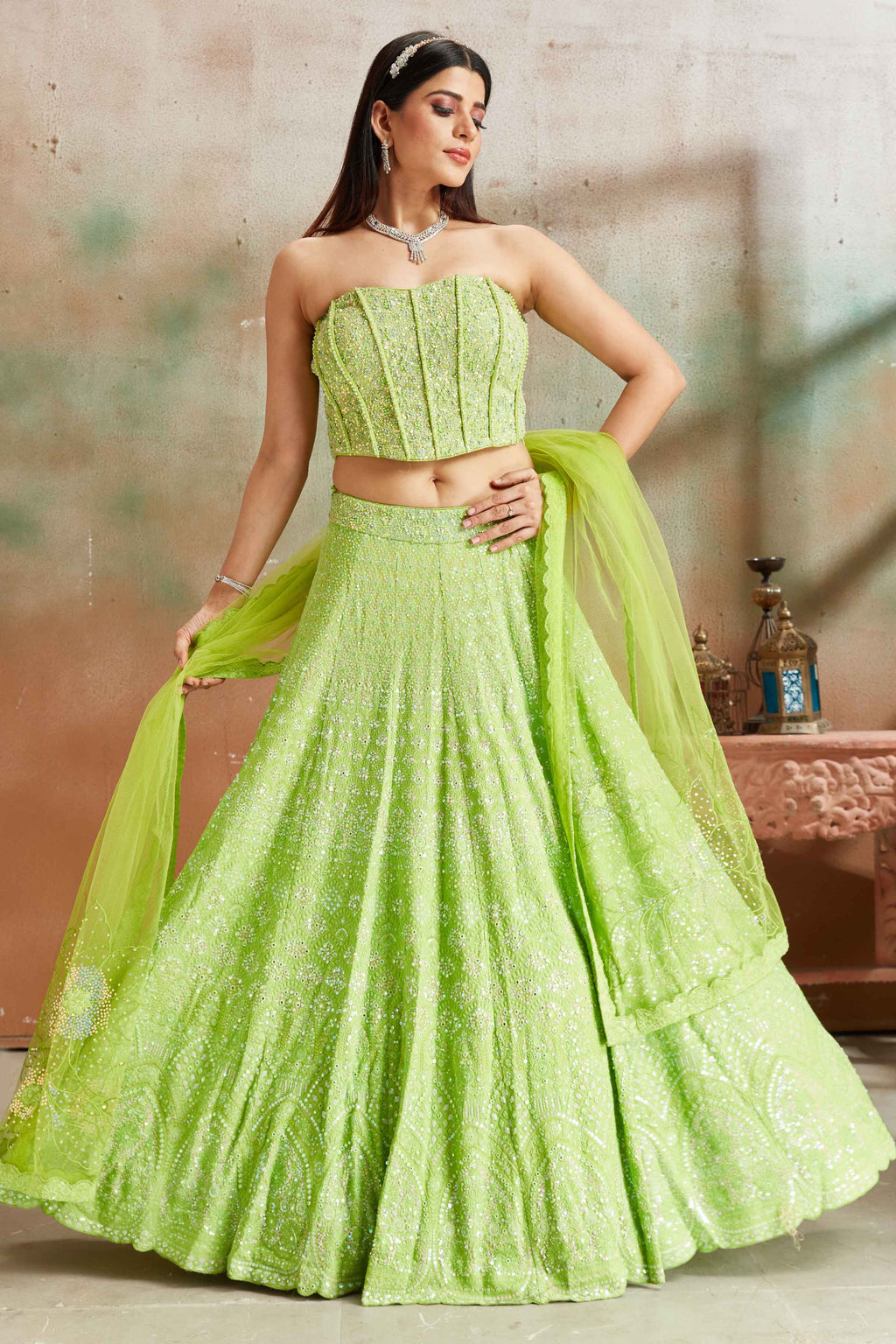 Buy pastel green Lucknowi georgette lehenga online in USA with corset blouse and dupatta. Look your best on festive occasions in latest designer saris, pure silk sarees, Kanjivaram silk sarees, handwoven saris, tussar silk sarees, embroidered saris from Pure Elegance Indian clothing store in USA.-front