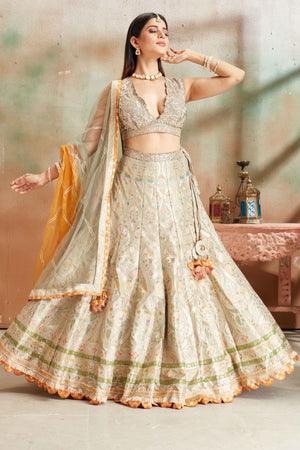 Buy sage green embroidered Banarasi silk lehenga online in USA with dupatta. Look your best on festive occasions in latest designer saris, pure silk sarees, Kanjivaram silk sarees, handwoven saris, tussar silk sarees, embroidered saris from Pure Elegance Indian clothing store in USA.-front