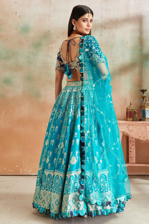 Shop sea green embroidered Banarasi silk lehenga online in USA with blue blouse. Look your best on festive occasions in latest designer saris, pure silk sarees, Kanjivaram silk sarees, handwoven saris, tussar silk sarees, embroidered saris from Pure Elegance Indian clothing store in USA.-back