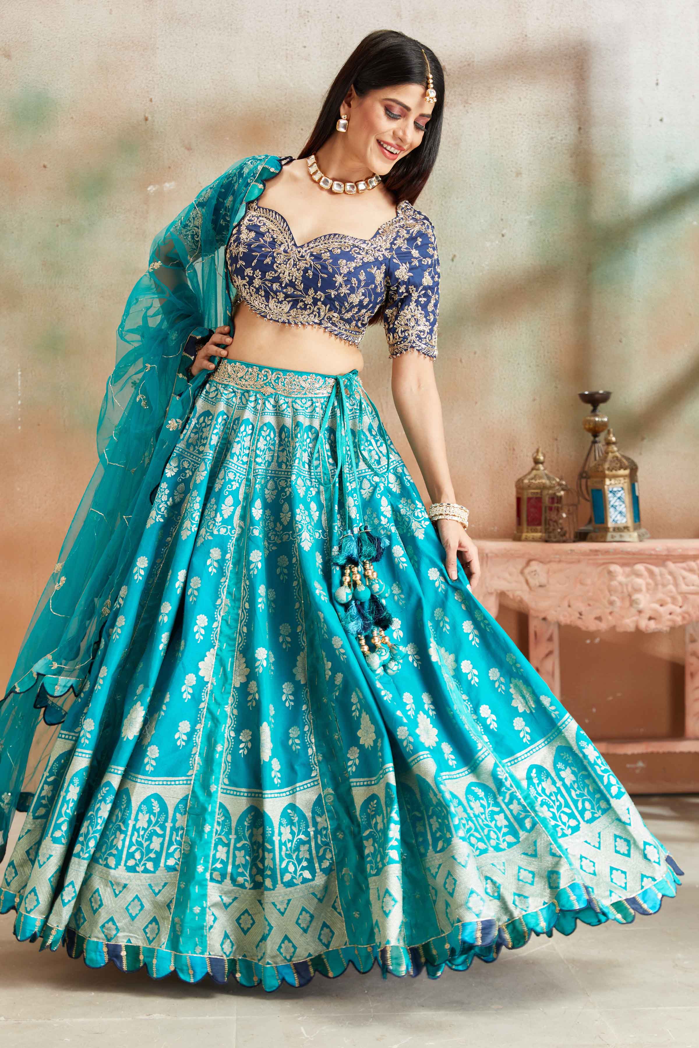 Shop sea green embroidered Banarasi silk lehenga online in USA with blue blouse. Look your best on festive occasions in latest designer saris, pure silk sarees, Kanjivaram silk sarees, handwoven saris, tussar silk sarees, embroidered saris from Pure Elegance Indian clothing store in USA.-front