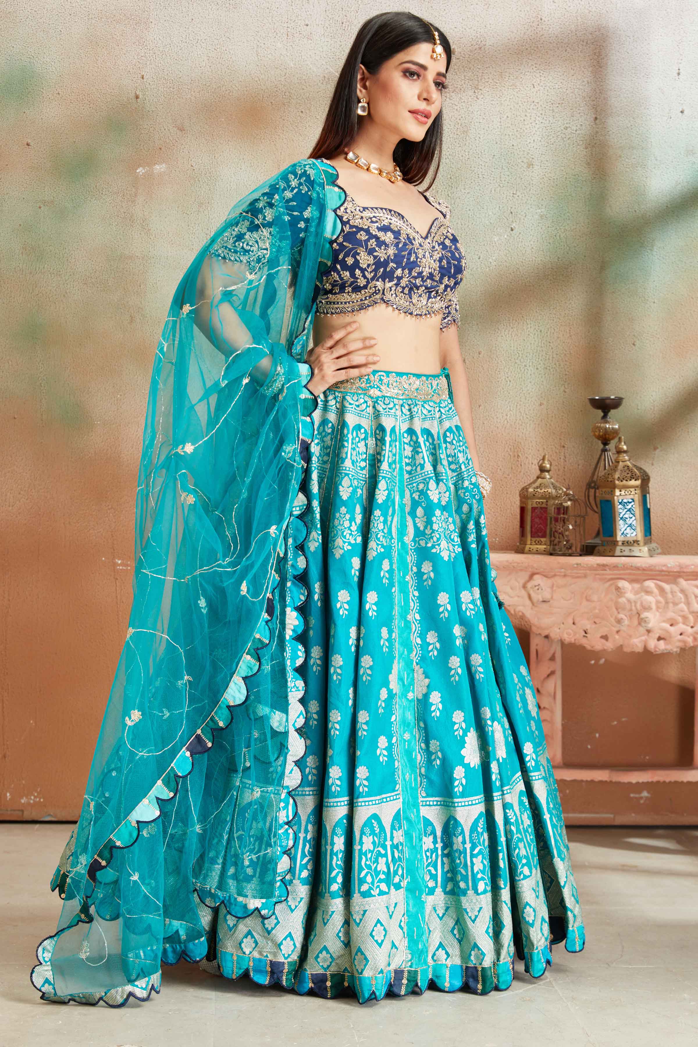 Shop sea green embroidered Banarasi silk lehenga online in USA with blue blouse. Look your best on festive occasions in latest designer saris, pure silk sarees, Kanjivaram silk sarees, handwoven saris, tussar silk sarees, embroidered saris from Pure Elegance Indian clothing store in USA.-side