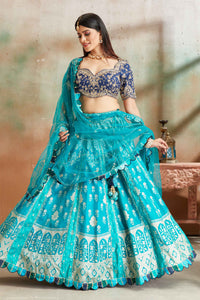 Shop sea green embroidered Banarasi silk lehenga online in USA with blue blouse. Look your best on festive occasions in latest designer saris, pure silk sarees, Kanjivaram silk sarees, handwoven saris, tussar silk sarees, embroidered saris from Pure Elegance Indian clothing store in USA.-full view