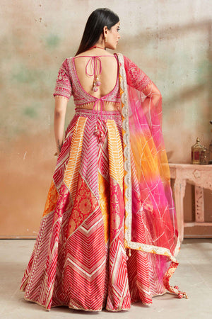 Buy orange and pink embroidered Banarasi silk lehenga online in USA with dupatta. Look your best on festive occasions in latest designer saris, pure silk sarees, Kanjivaram silk sarees, handwoven saris, tussar silk sarees, embroidered saris from Pure Elegance Indian clothing store in USA.-back