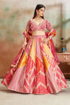 Buy orange and pink embroidered Banarasi silk lehenga online in USA with dupatta. Look your best on festive occasions in latest designer saris, pure silk sarees, Kanjivaram silk sarees, handwoven saris, tussar silk sarees, embroidered saris from Pure Elegance Indian clothing store in USA.-full view