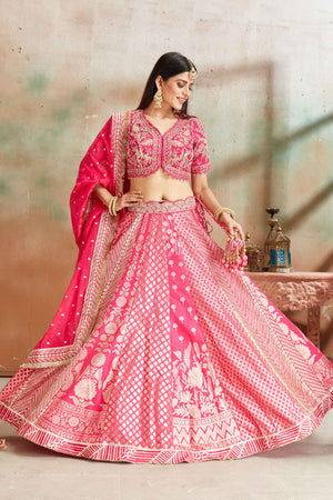 Buy fuschia pink embroidered Banarasi silk lehenga online in USA with dupatta. Look your best on festive occasions in latest designer saris, pure silk sarees, Kanjivaram silk sarees, handwoven saris, tussar silk sarees, embroidered saris from Pure Elegance Indian clothing store in USA.-front