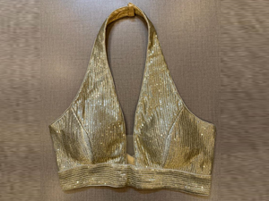 Buy golden embellished halter neck saree blouse online in USA. Elevate your saree style with exquisite readymade sari blouses, embroidered saree blouses, Banarasi sari blouse, designer saree blouse, choli-cut blouses, corset blouses from Pure Elegance Indian fashion store in USA.-full view