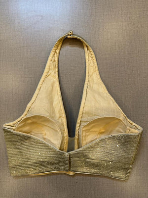 Buy golden embellished halter neck saree blouse online in USA. Elevate your saree style with exquisite readymade sari blouses, embroidered saree blouses, Banarasi sari blouse, designer saree blouse, choli-cut blouses, corset blouses from Pure Elegance Indian fashion store in USA.-back
