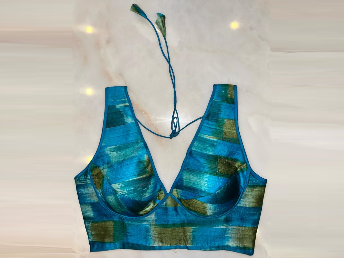 Shop blue and green sleeveless saree blouse online in USA with v-neckline. Elevate your saree style with exquisite readymade sari blouses, embroidered saree blouses, Banarasi sari blouse, designer saree blouse, choli-cut blouses, corset blouses from Pure Elegance Indian fashion store in USA.-full view