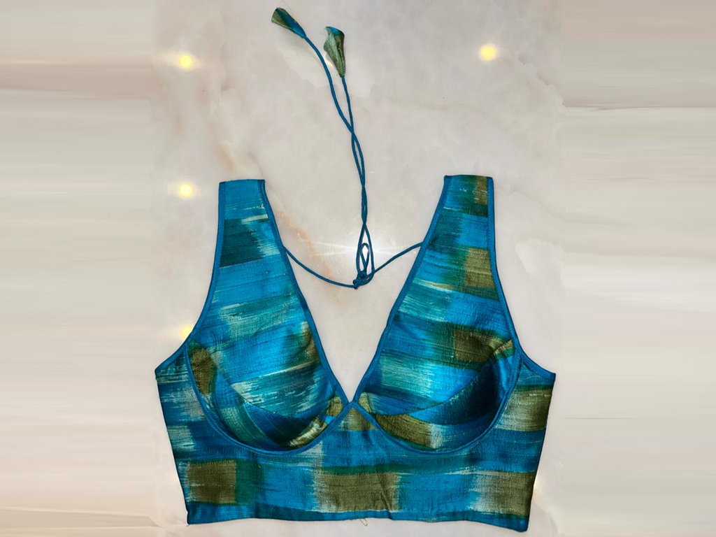 Shop blue and green sleeveless saree blouse online in USA with v-neckline. Elevate your saree style with exquisite readymade sari blouses, embroidered saree blouses, Banarasi sari blouse, designer saree blouse, choli-cut blouses, corset blouses from Pure Elegance Indian fashion store in USA.-full view