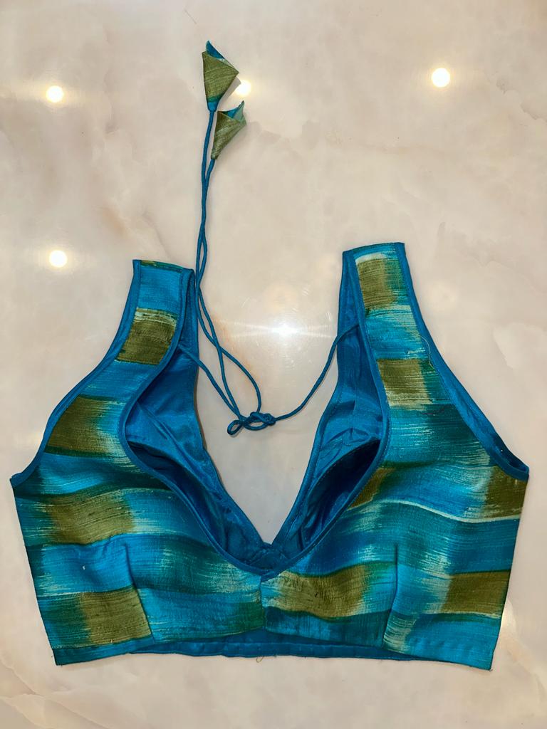 Shop blue and green sleeveless saree blouse online in USA with v-neckline. Elevate your saree style with exquisite readymade sari blouses, embroidered saree blouses, Banarasi sari blouse, designer saree blouse, choli-cut blouses, corset blouses from Pure Elegance Indian fashion store in USA.-back