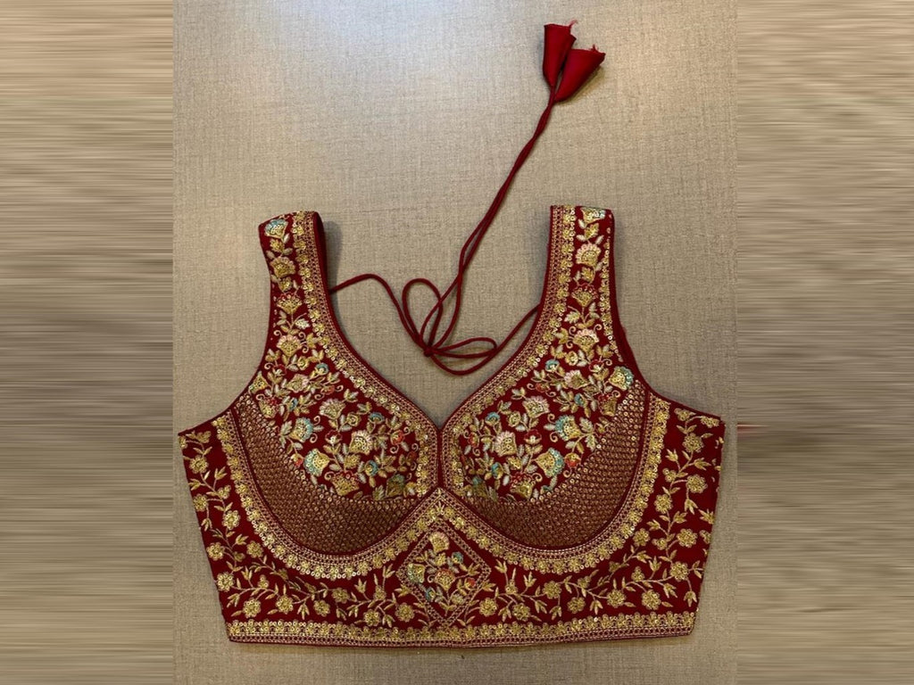 Buy maroon heavy embroidery sleeveless saree blouse online in USA. Elevate your saree style with exquisite readymade sari blouses, embroidered saree blouses, Banarasi sari blouse, designer saree blouse, choli-cut blouses, corset blouses from Pure Elegance Indian fashion store in USA.-front