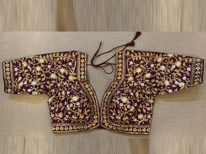 Shop stunning maroon heavy embroidered saree blouse online in USA. Elevate your saree style with exquisite readymade sari blouses, embroidered saree blouses, Banarasi sari blouse, designer saree blouse, choli-cut blouses, corset blouses from Pure Elegance Indian fashion store in USA.-front