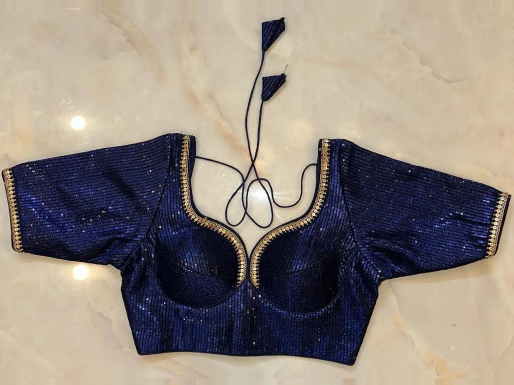 Shop navy blue sequin choli-cut saree blouse online in USA with golden lace. Elevate your saree style with exquisite readymade sari blouses, embroidered saree blouses, Banarasi sari blouse, designer saree blouse, choli-cut blouses, corset blouses from Pure Elegance Indian fashion store in USA.-full view