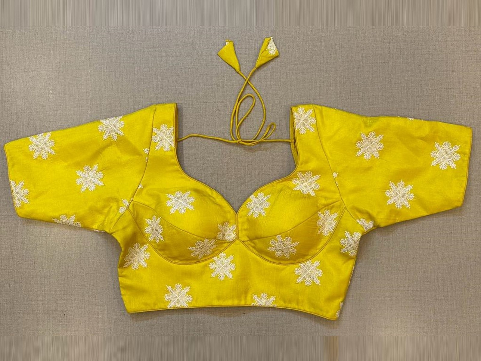 Buy yellow choli cut blouse online in USA with white floral motifs. Elevate your saree style with exquisite readymade sari blouses, embroidered saree blouses, Banarasi sari blouse, designer saree blouse, choli-cut blouses, corset blouses from Pure Elegance Indian fashion store in USA.-full view