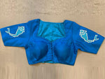 Shop beautiful turquoise blue blouse online in USA with fish motif on sleeves. Elevate your saree style with exquisite readymade sari blouses, embroidered saree blouses, Banarasi sari blouse, designer saree blouse, choli-cut blouses, corset blouses from Pure Elegance Indian fashion store in USA.-full view