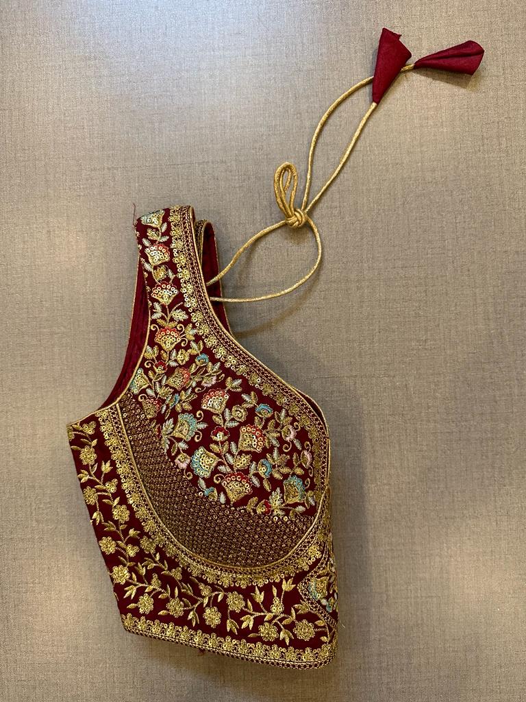 Buy maroon heavy embroidery sleeveless saree blouse online in USA. Elevate your saree style with exquisite readymade sari blouses, embroidered saree blouses, Banarasi sari blouse, designer saree blouse, choli-cut blouses, corset blouses from Pure Elegance Indian fashion store in USA.-side