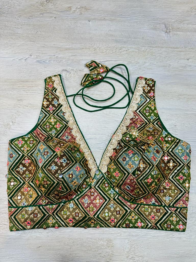 Buy green multicolor sleeveless blouse with thread and mirror embroidery. Make a fashion statement on festive occasions and weddings with designer blouses, designer sarees, designer suits, Indian dresses, designer gowns, sharara suits, and embroidered sarees from Pure Elegance Indian fashion store in the USA.