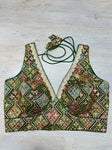 Buy green multicolor sleeveless blouse with thread and mirror embroidery. Make a fashion statement on festive occasions and weddings with designer blouses, designer sarees, designer suits, Indian dresses, designer gowns, sharara suits, and embroidered sarees from Pure Elegance Indian fashion store in the USA.