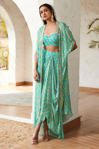 Buy a blue printed skirt set adorned with a strappy blouse & printed cape. Dazzle on weddings and special occasions with exquisite Indian designer dresses, sharara suits, Anarkali suits, and wedding lehengas from Pure Elegance Indian fashion store in the USA.