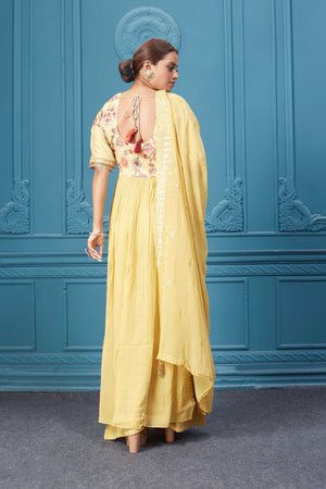 Shop a yellow naira cut suit set with mirror work and embroidered kurta, plazzo, 3/4th sleeves, and beautiful mirror work embroidered dupatta. Dazzle on special occasions with exquisite Indian designer dresses, sharara suits, Anarkali suits, bridal lehengas, and sharara suits from Pure Elegance Indian clothing store in the USA. Shop online from Pure Elegance.