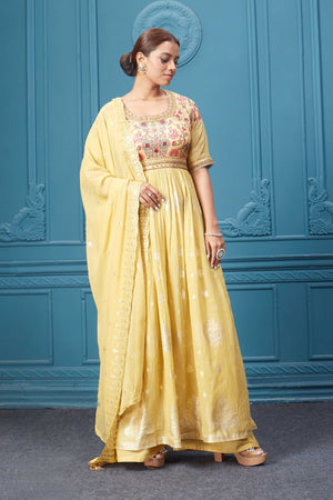 Shop a yellow naira cut suit set with mirror work and embroidered kurta, plazzo, 3/4th sleeves, and beautiful mirror work embroidered dupatta. Dazzle on special occasions with exquisite Indian designer dresses, sharara suits, Anarkali suits, bridal lehengas, and sharara suits from Pure Elegance Indian clothing store in the USA. Shop online from Pure Elegance.