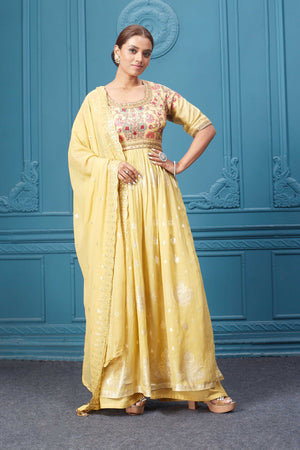 Shop a yellow naira cut suit set with mirror work and embroidered kurta, plazzo, 3/4th sleeves, and beautiful mirror work embroidered dupatta. Dazzle on special occasions with exquisite Indian designer dresses, sharara suits, Anarkali suits, bridal lehengas, and sharara suits from Pure Elegance Indian clothing store in the USA. Shop online from Pure Elegance.