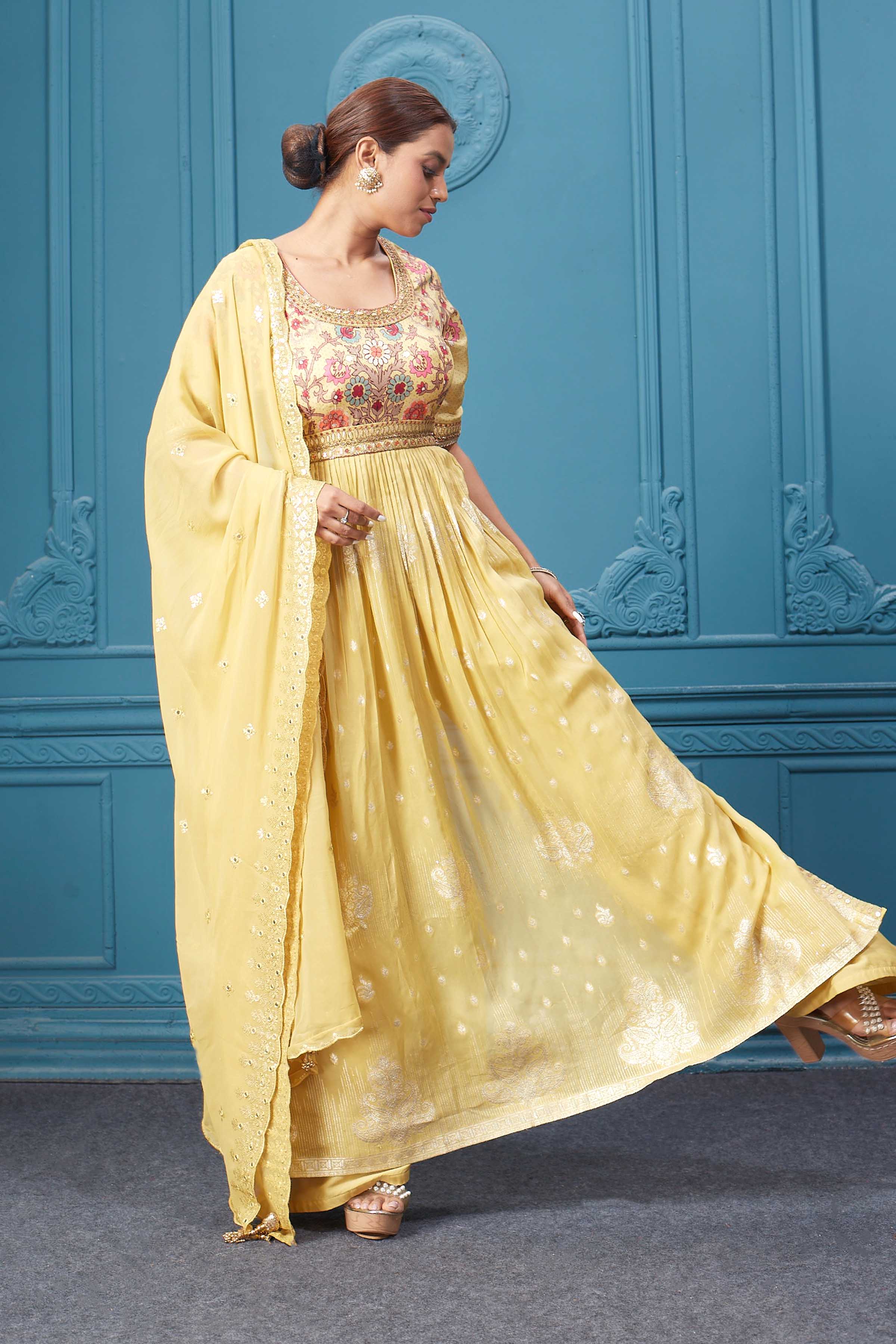 Shop a yellow naira cut suit set with mirror work and embroidered kurta, plazzo, 3/4th sleeves, and beautiful mirror work embroidered dupatta. Dazzle on special occasions with exquisite Indian designer dresses, sharara suits, Anarkali suits, bridal lehengas, and sharara suits from Pure Elegance Indian clothing store in the USA. Shop online from Pure Elegance.