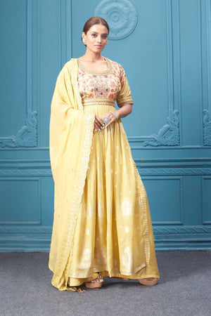 Shop a yellow naira cut suit set with mirror work and embroidered kurta, plazzo, 3/4th sleeves, and beautiful mirror work embroidered dupatta. Dazzle on special occasions with exquisite Indian designer dresses, sharara suits, Anarkali suits, bridal lehengas, and sharara suits from Pure Elegance Indian clothing store in the USA. Shop online from Pure Elegance.