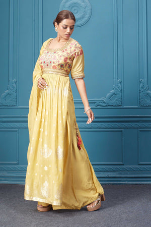 Shop a yellow naira cut suit set with mirror work and embroidered kurta, plazzo, 3/4th sleeves, and beautiful mirror work embroidered dupatta. Dazzle on special occasions with exquisite Indian designer dresses, sharara suits, Anarkali suits, bridal lehengas, and sharara suits from Pure Elegance Indian clothing store in the USA. Shop online from Pure Elegance.