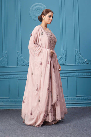 Shop a light pink embroidered sleeveless Anarkali kurta featuring mirror embroidery, embroidered bordered plazzo, and tassel work dupatta. Dazzle on special occasions with exquisite Indian designer dresses, sharara suits, Anarkali suits, bridal lehengas, and sharara suits from Pure Elegance Indian clothing store in the USA. Shop online from Pure Elegance.