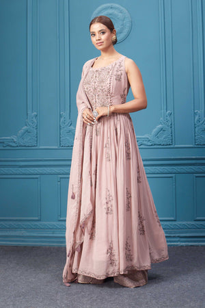 Shop a light pink embroidered sleeveless Anarkali kurta featuring mirror embroidery, embroidered bordered plazzo, and tassel work dupatta. Dazzle on special occasions with exquisite Indian designer dresses, sharara suits, Anarkali suits, bridal lehengas, and sharara suits from Pure Elegance Indian clothing store in the USA. Shop online from Pure Elegance.