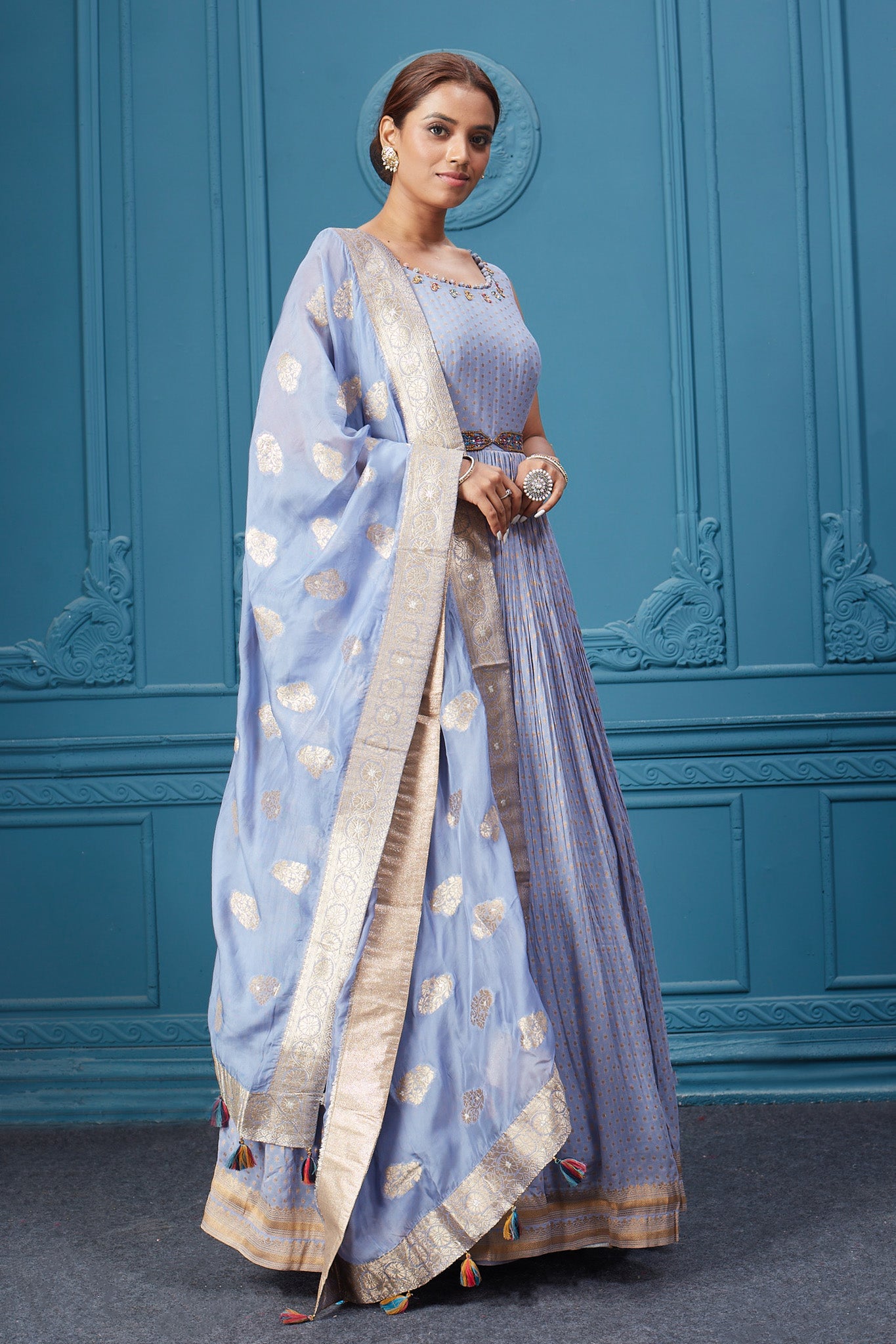 Buy a light blue embroidered sleeveless Anarkali kurta featuring embroidery, belt, and an embroidered dupatta with tassels. Dazzle on special occasions with exquisite Indian designer dresses, sharara suits, Anarkali suits, bridal lehengas, and sharara suits from Pure Elegance Indian clothing store in the USA. Shop online from Pure Elegance.