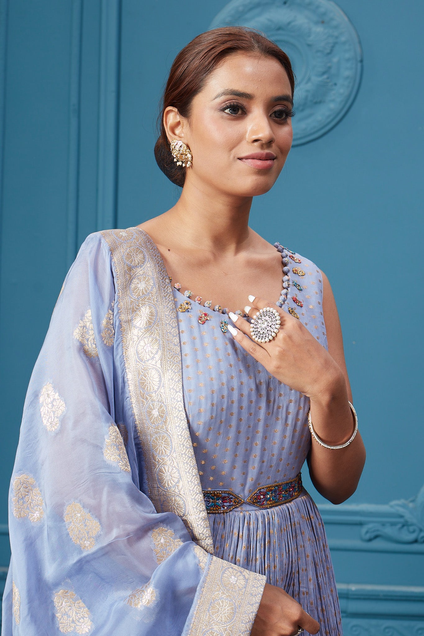 Buy a light blue embroidered sleeveless Anarkali kurta featuring embroidery, belt, and an embroidered dupatta with tassels. Dazzle on special occasions with exquisite Indian designer dresses, sharara suits, Anarkali suits, bridal lehengas, and sharara suits from Pure Elegance Indian clothing store in the USA. Shop online from Pure Elegance.