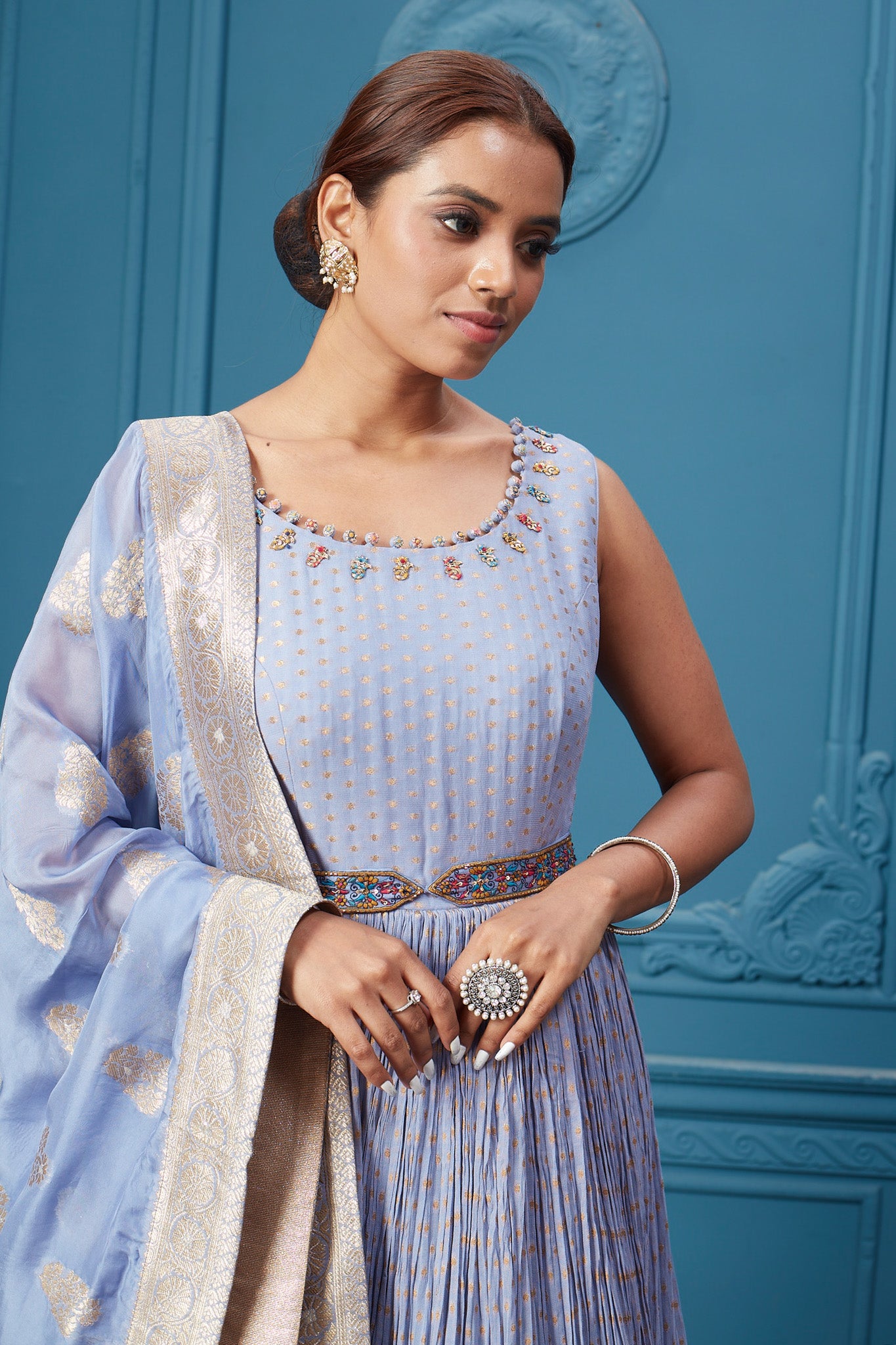 Buy a light blue embroidered sleeveless Anarkali kurta featuring embroidery, belt, and an embroidered dupatta with tassels. Dazzle on special occasions with exquisite Indian designer dresses, sharara suits, Anarkali suits, bridal lehengas, and sharara suits from Pure Elegance Indian clothing store in the USA. Shop online from Pure Elegance.