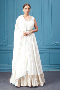 Buy a white embroidered sleeveless Anarkali kurta featuring mirror embroidery, embroidered borders, and a dupatta. Dazzle on special occasions with exquisite Indian designer dresses, sharara suits, Anarkali suits, bridal lehengas, and sharara suits from Pure Elegance Indian clothing store in the USA. Shop online from Pure Elegance.