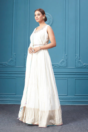 Buy a white embroidered sleeveless Anarkali kurta featuring mirror embroidery, embroidered borders, and a dupatta. Dazzle on special occasions with exquisite Indian designer dresses, sharara suits, Anarkali suits, bridal lehengas, and sharara suits from Pure Elegance Indian clothing store in the USA. Shop online from Pure Elegance.