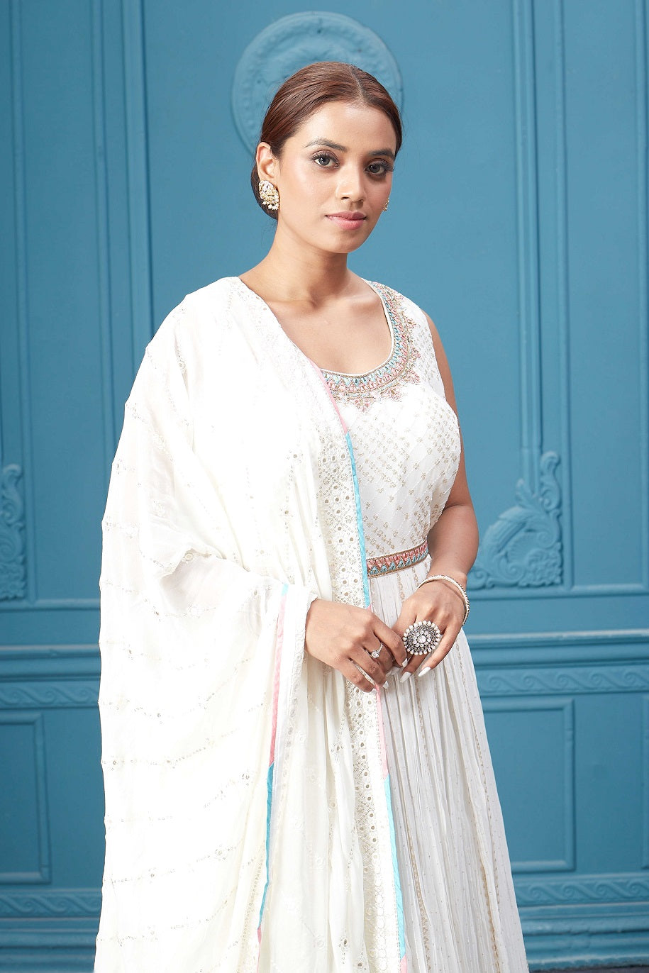 Buy a white embroidered sleeveless Anarkali kurta featuring mirror embroidery, embroidered borders, and a dupatta. Dazzle on special occasions with exquisite Indian designer dresses, sharara suits, Anarkali suits, bridal lehengas, and sharara suits from Pure Elegance Indian clothing store in the USA. Shop online from Pure Elegance.