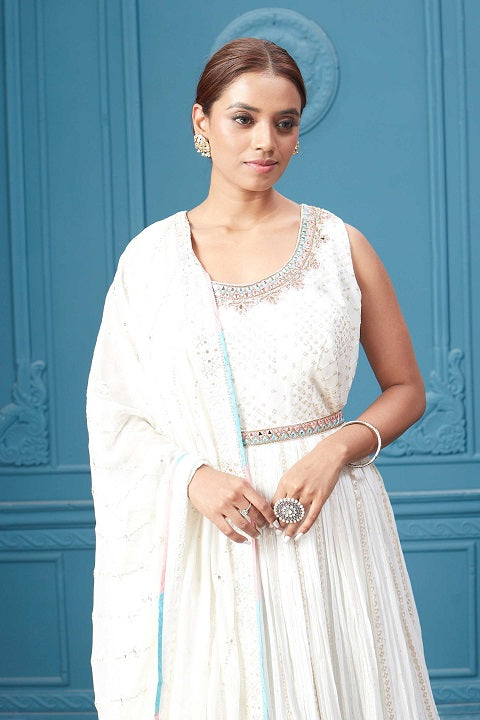 Buy a white embroidered sleeveless Anarkali kurta featuring mirror embroidery, embroidered borders, and a dupatta. Dazzle on special occasions with exquisite Indian designer dresses, sharara suits, Anarkali suits, bridal lehengas, and sharara suits from Pure Elegance Indian clothing store in the USA. Shop online from Pure Elegance.