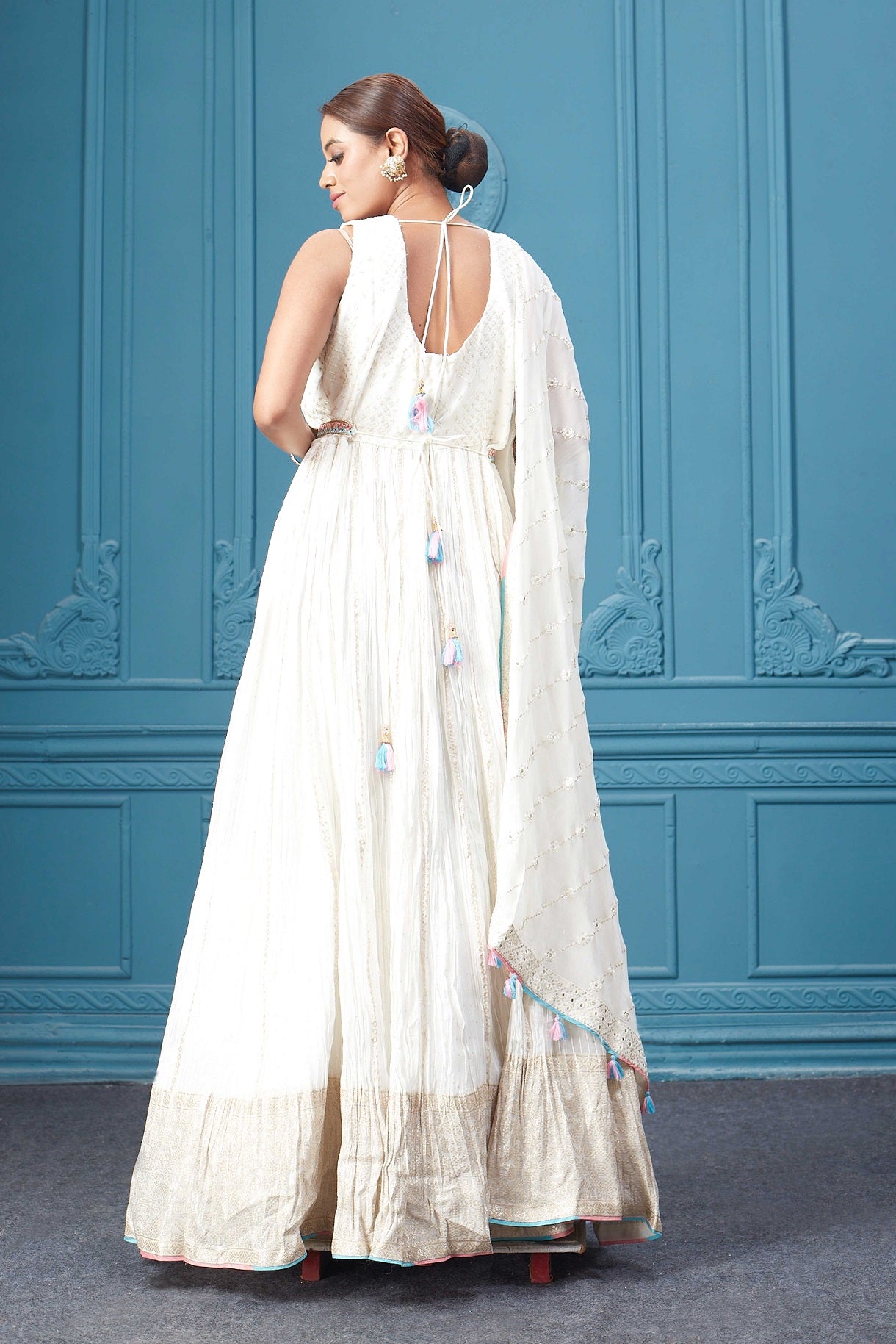 Buy a white embroidered sleeveless Anarkali kurta featuring mirror embroidery, embroidered borders, and a dupatta. Dazzle on special occasions with exquisite Indian designer dresses, sharara suits, Anarkali suits, bridal lehengas, and sharara suits from Pure Elegance Indian clothing store in the USA. Shop online from Pure Elegance.