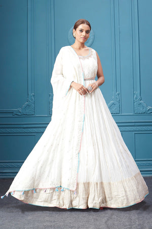 Buy a white embroidered sleeveless Anarkali kurta featuring mirror embroidery, embroidered borders, and a dupatta. Dazzle on special occasions with exquisite Indian designer dresses, sharara suits, Anarkali suits, bridal lehengas, and sharara suits from Pure Elegance Indian clothing store in the USA. Shop online from Pure Elegance.