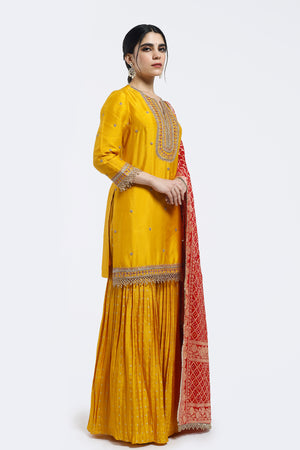 Buy yellow embroidered silk gharara suit online in USA with pink dupatta. Shop the best and latest designs in embroidered sarees, designer sarees, Anarkali suit, lehengas, sharara suits for weddings and special occasions from Pure Elegance Indian fashion store in USA.-side