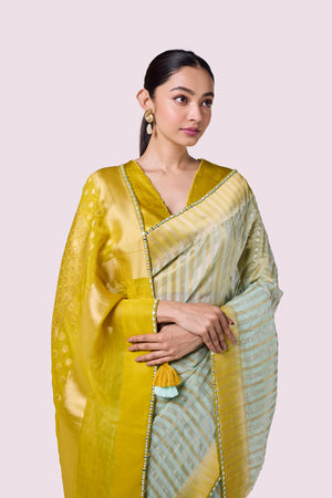 Buy aqua and mustard organza saree online in USA with mashru silk saree blouse. Look your best at parties and weddings in beautiful designer sarees, embroidered sarees, handwoven sarees, silk sarees, organza saris from Pure Elegance Indian saree store in USA.-closeup