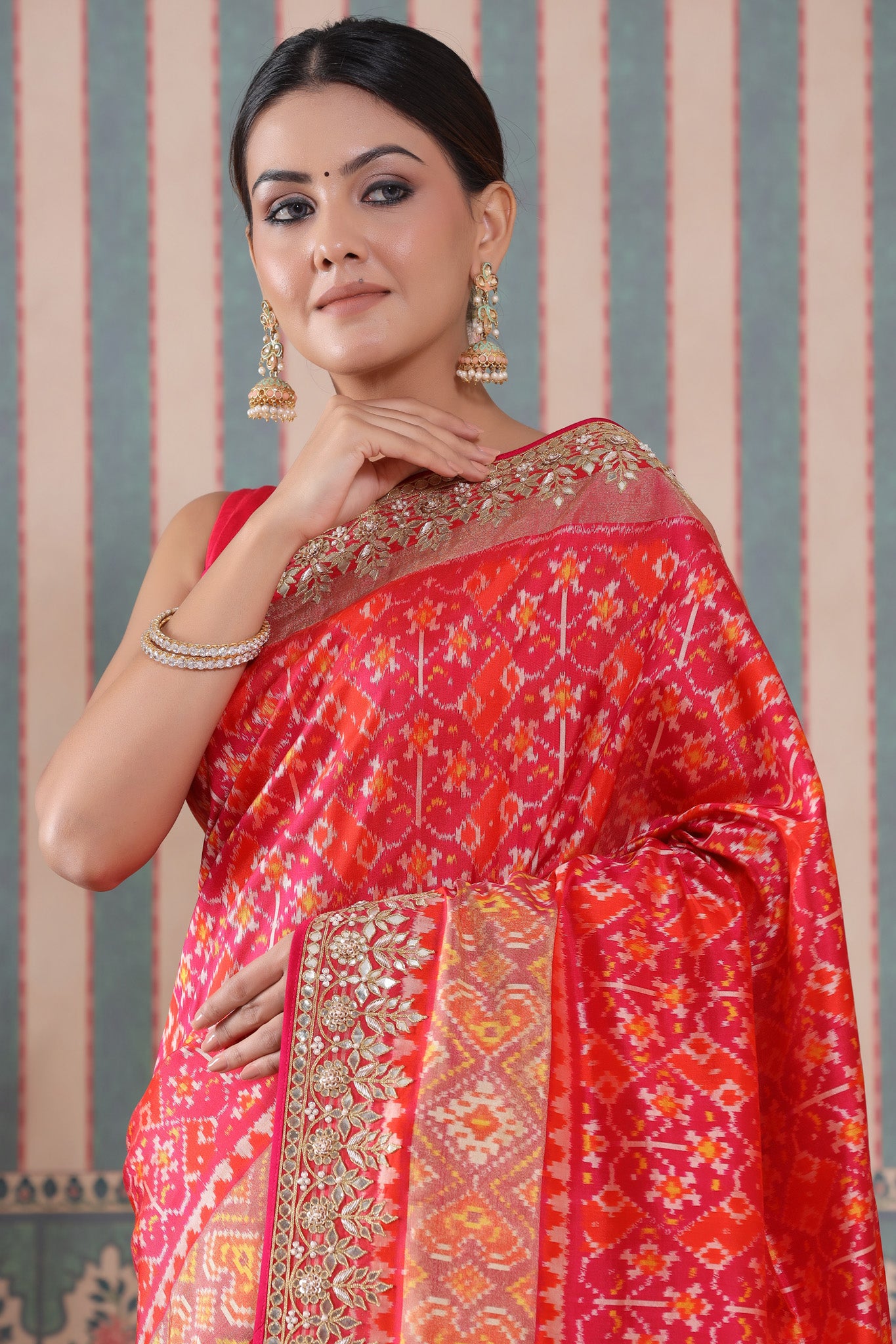 Shop pink and orange Patola silk sari online in USA with embroidered border. Make a fashion statement at weddings with stunning designer sarees, embroidered sarees with blouse, wedding sarees, handloom sarees from Pure Elegance Indian fashion store in USA.-closeup