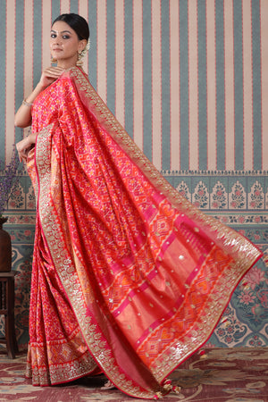 Shop pink and orange Patola silk sari online in USA with embroidered border. Make a fashion statement at weddings with stunning designer sarees, embroidered sarees with blouse, wedding sarees, handloom sarees from Pure Elegance Indian fashion store in USA.-pallu